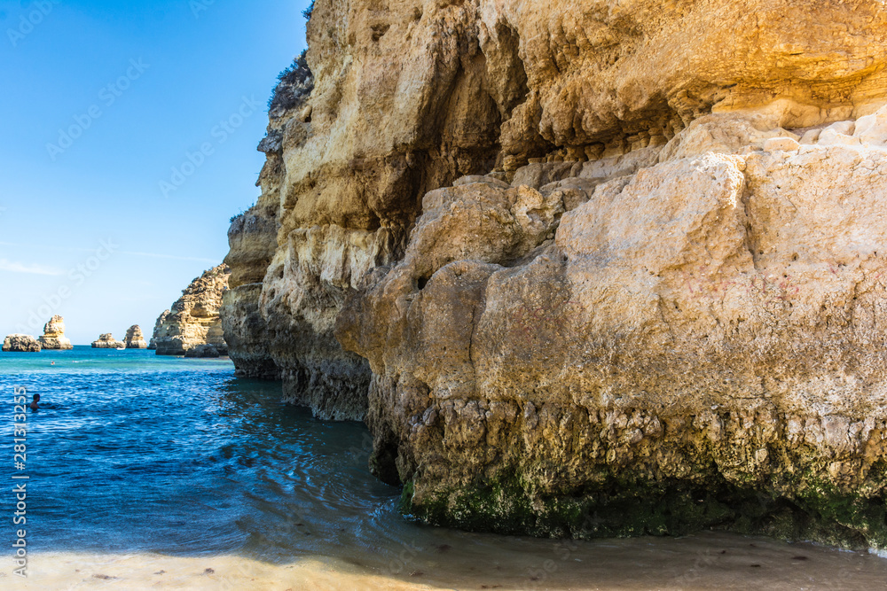 Cliffs and rocky caves on Dona Ana beach in Lagoa, Algarve (Portugal)
