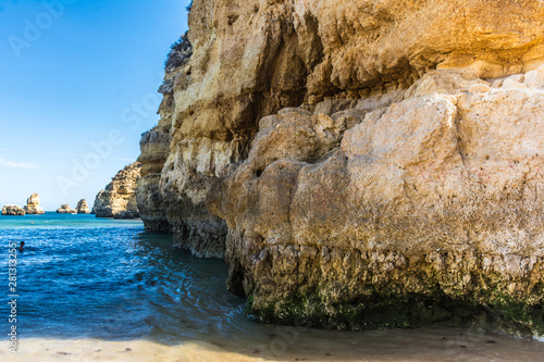 Cliffs and rocky caves on Dona Ana beach in Lagoa, Algarve (Portugal)