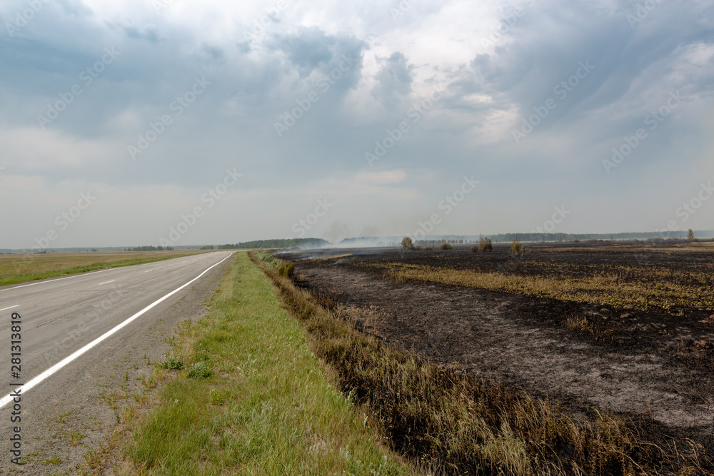 dry grass burning on the field on a hot day