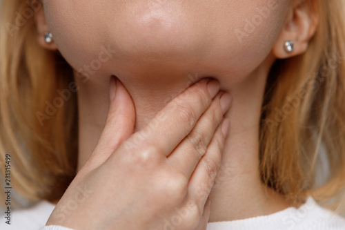 Closeup of sick woman suffering from throat problems. Thyroid gland, painful swallowing, tonsillitis concept. Inflammation of the upper respiratory tract © DimaBerlin