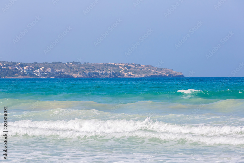 Beautiful blue turquoise water and seashore with waves and foam