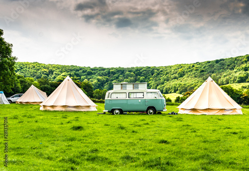 An iconic camper van at a glamping site in the English countryside