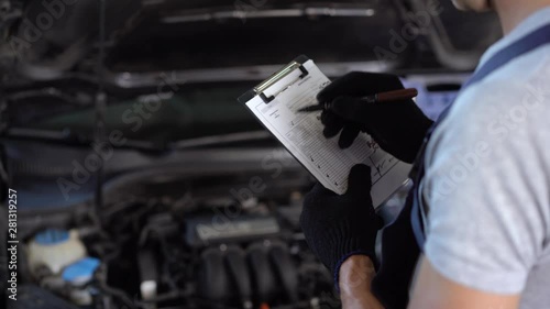Mechanic repairman inspecting car