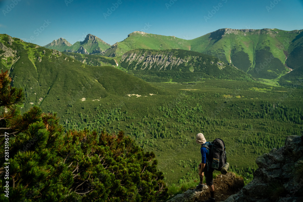 Fototapeta premium Hiker enjoys the view of High Tatras mountain valley