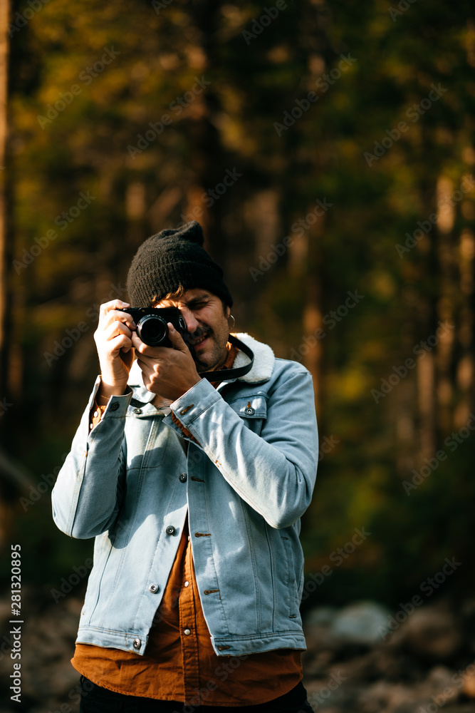 handsome and stylish man takes photo in nature handsome and stylish man takes photo in nature