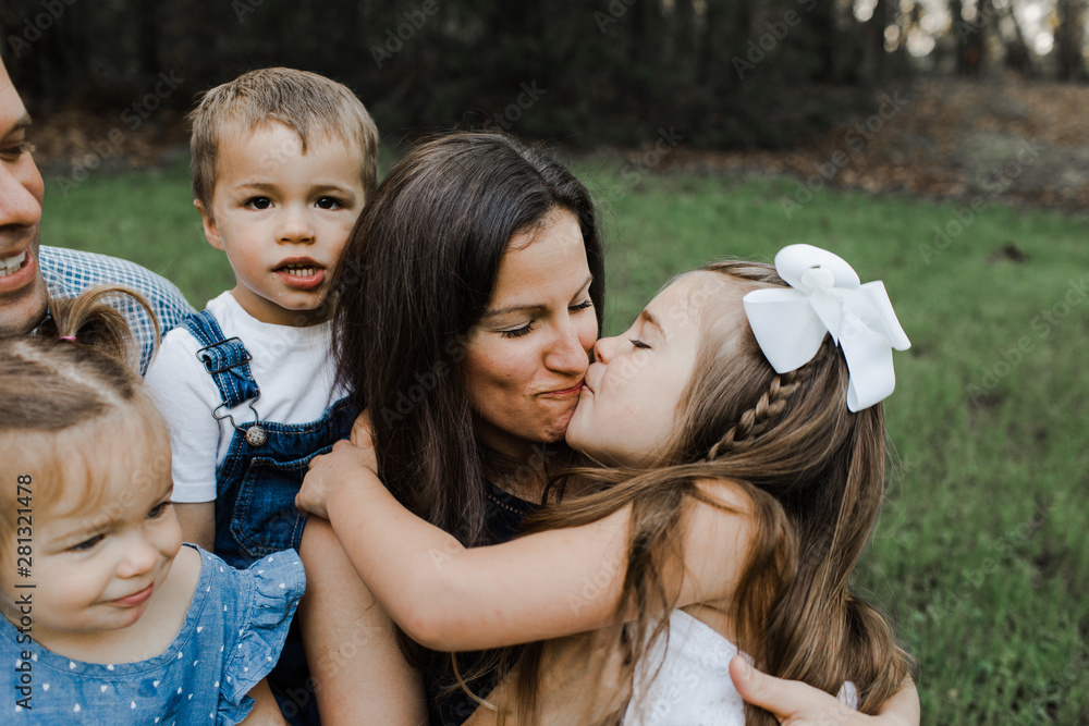 little girl kissing mom Stock Photo Adobe Stock