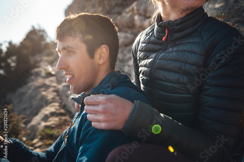 Intimate moment of a couple of climbers sharing the summit of a multipitches route