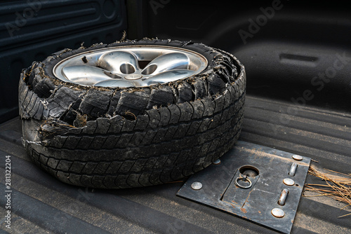 Blown tire in the bed of a pick up truck.