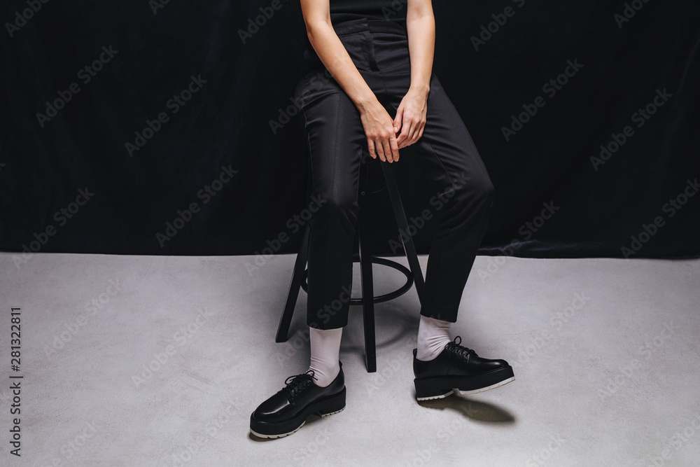 A Woman Wearing Black Shoes and White Socks A Woman Wearing Black Shoes and White Socks
