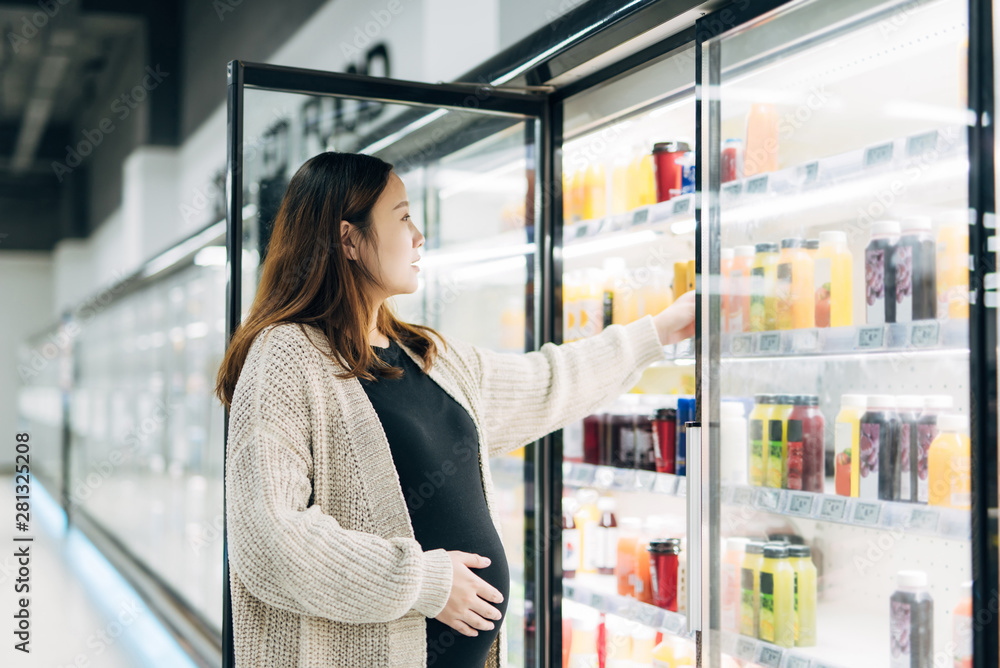 Pregnant woman shopping in supermarket Pregnant woman shopping in supermarket