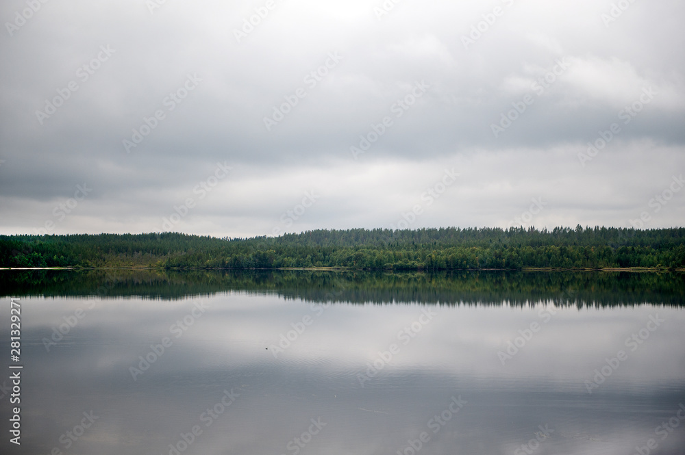 Fototapeta premium Forest lake, early autumn morning, Karelia, Russia, north. forest landscape reflected in water