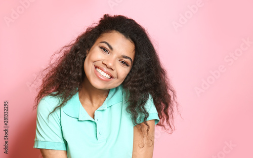 Portrait of cute African-American woman on color background