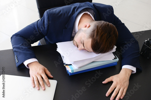 Tired businessman sleeping ...
