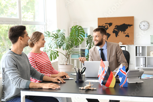 Male travel agent working w...