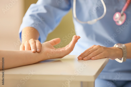 Wallpaper Mural Doctor measuring pulse of young woman in clinic Torontodigital.ca