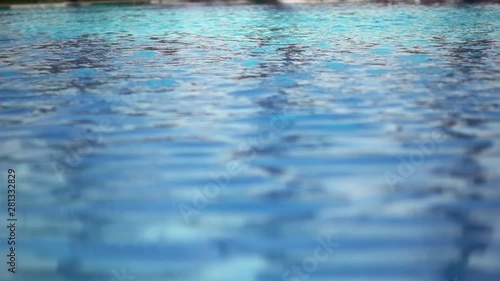 Close-up Shot Of Pool Water features a close-up shot of the clear blue waters of a swimming pool. It appears like the video was taken on a sunny day and the pool looks clean and soothing.