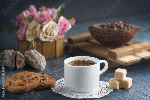 Morning coffee with cookies and pieces of cane sugar, coffee beans and dried fruits