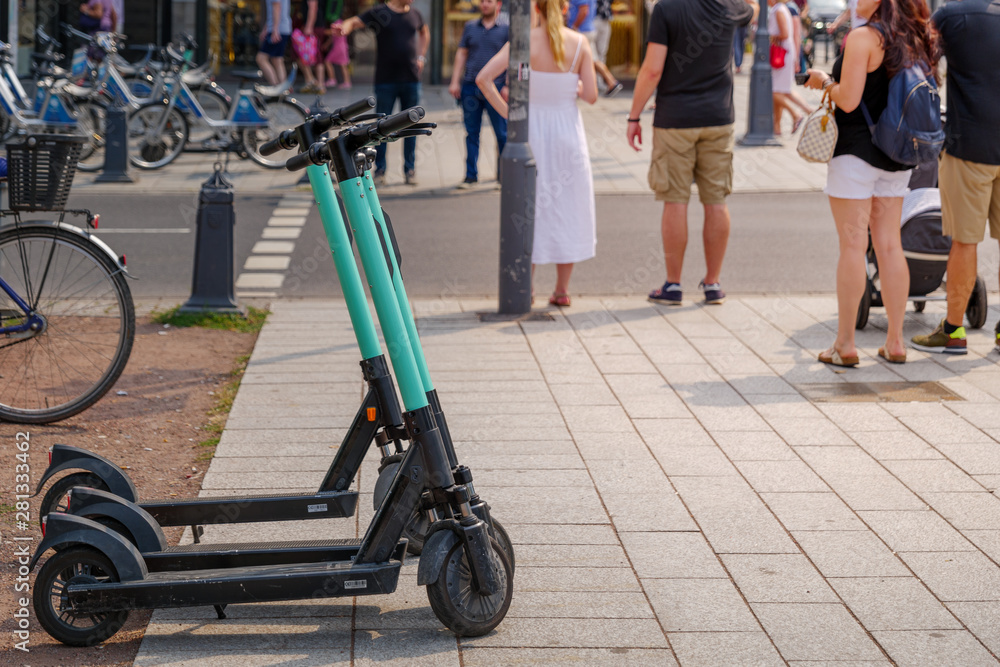 Parking E-scooter from startup company with idea of Eco friendly mobility  concept of sharing Electric Scooter, park at Königsallee in Düsseldorf,  Germany. Electric scooters on sidewalk in europe Photos | Adobe Stock