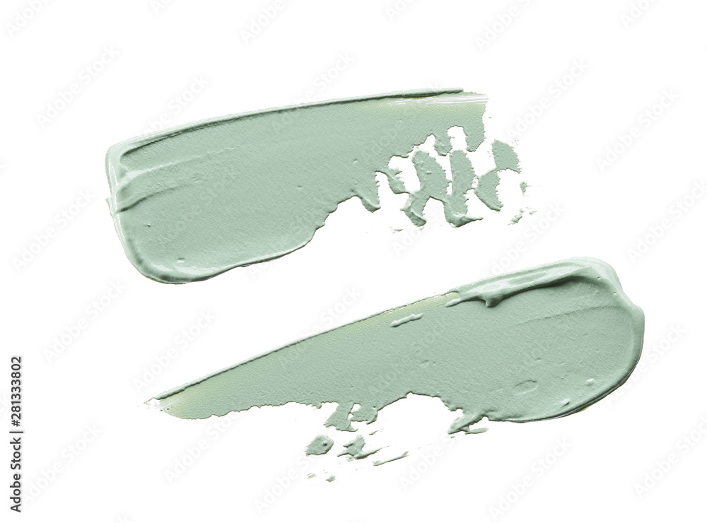 Fototapeta premium Gently green strokes and texture of face cream or acrylic paint isolated on white background