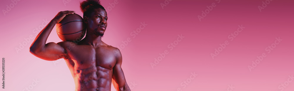 panoramic shot of african american basketball player holding ball and looking away on pink and purple gradient background panoramic shot of african american basketball player holding ball and looking away on pink and purple gradient background