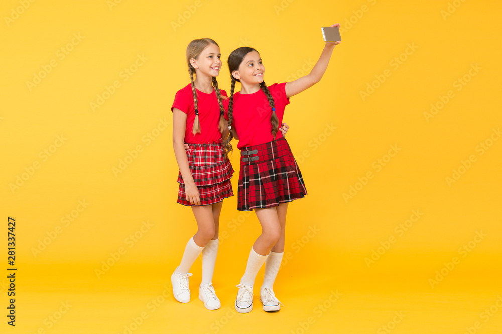 Children girls hold smartphone. Taking selfie photo. Fashion blog. Blog online. Smartphone application concept. Blogger on social networks. Digital technology. Blogging modern trend. Personal blog Children girls hold smartphone. Taking selfie photo. Fashion blog. Blog online. Smartphone application concept. Blogger on social networks. Digital technology. Blogging modern trend. Personal blog