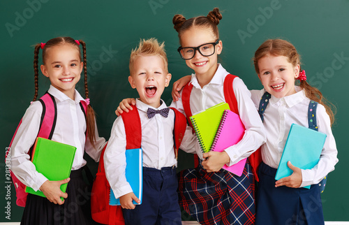 funny group children   schoolboy  and schoolgirl, student boy  and girl about school blackboard photo