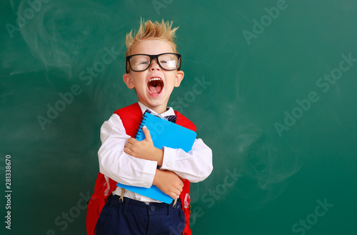 funny child   schoolboy  boy student about school blackboard. photo