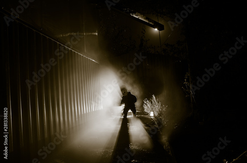 Horror scene of a scary children's ghost, Silhouette of scary baby doll on dark foggy background with light. © zef art