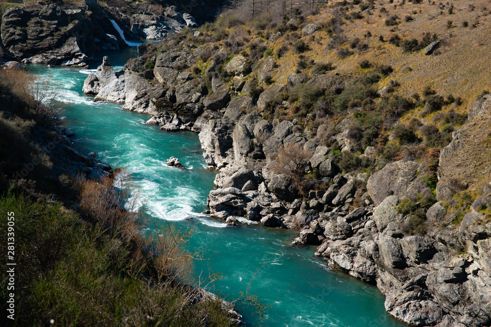 Turquoise water in the river flowing through the narrow gorge Turquoise water in the river flowing through the narrow gorge