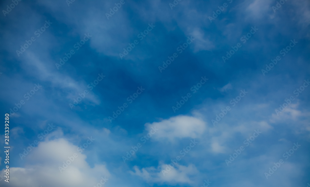 Obraz premium Blue sky with light white clouds cirrus and cumulus on a bright sunny clear day without rain during Spring.