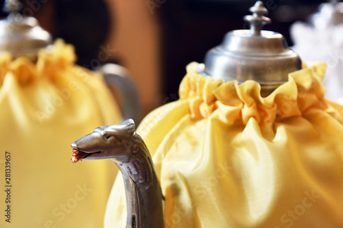 Thurible decorated with yellow and purple fabric, destined for burning incense during worship services.  photo