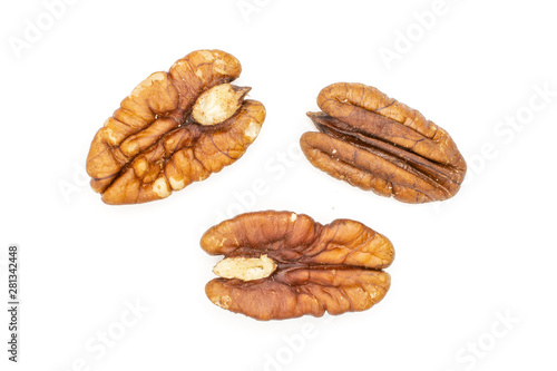Group of three whole fresh brown pecan nut half flatlay isolated on white background