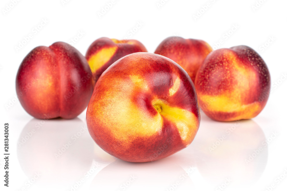 Group of five whole fresh red nectarine isolated on white background