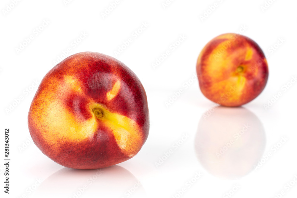 Group of two whole fresh red nectarine one is in the front isolated on white background Group of two whole fresh red nectarine one is in the front isolated on white background