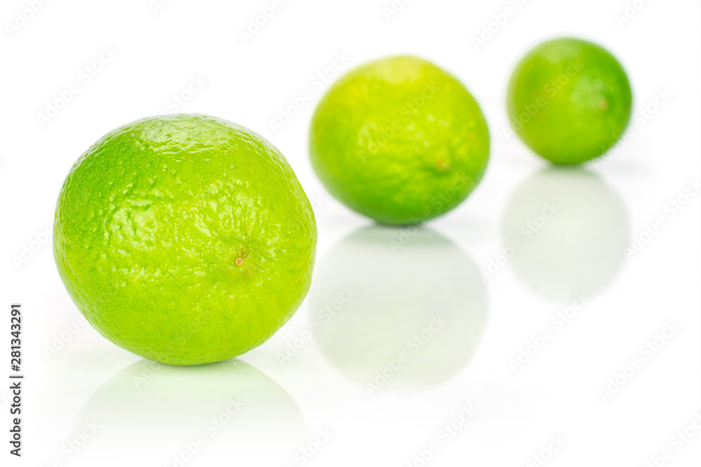 Group of three whole fresh green lime placed diagonally in a line isolated on white background Group of three whole fresh green lime placed diagonally in a line isolated on white background