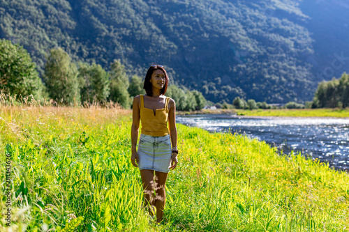 Obraz na płótnie woman traveler enjoying the scenic view of the Norwegian countryside in summer w salonie