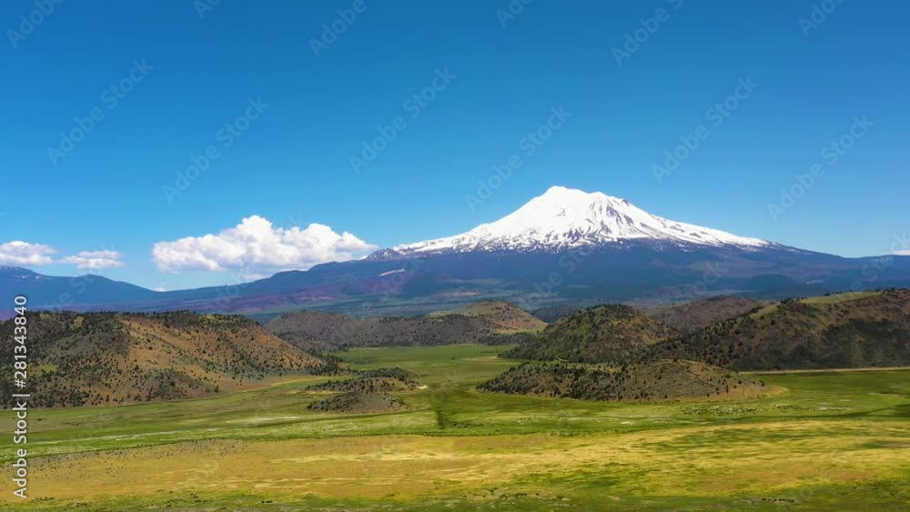 The snow-capped Peaks of Mt Shasta in the Cascade range of mountains Siskiyou County California. Slow pull-out shot with drone The snow-capped Peaks of Mt Shasta in the Cascade range of mountains Siskiyou County California. Slow pull-out shot with drone