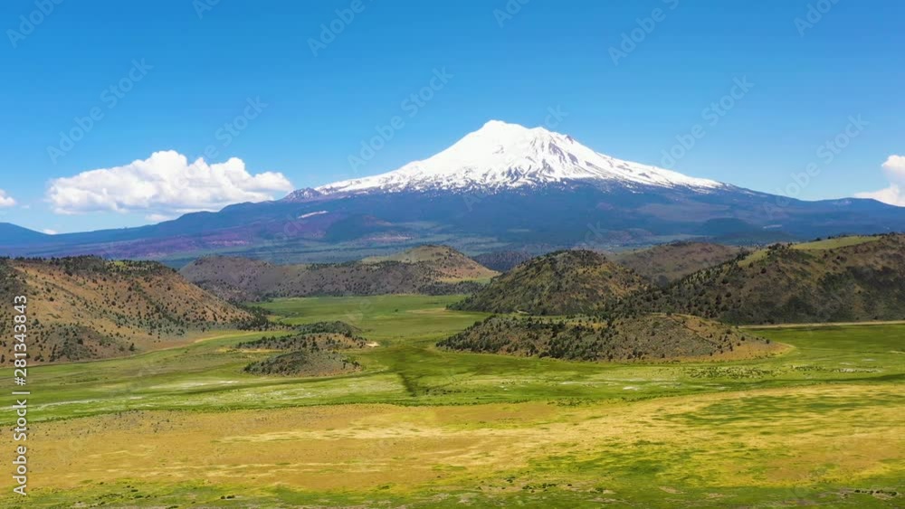 The snow-capped Peaks of Mt Shasta in the Cascade range of mountains Siskiyou County California. Gentle right pan with drone The snow-capped Peaks of Mt Shasta in the Cascade range of mountains Siskiyou County California. Gentle right pan with drone