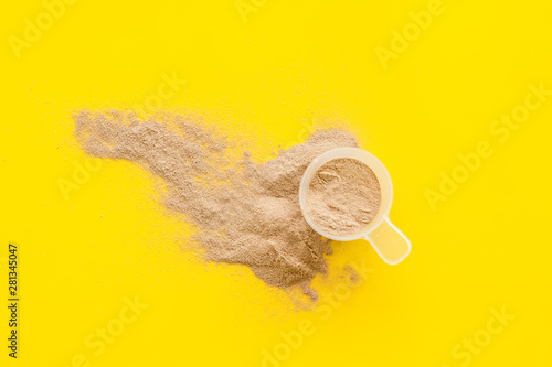 protein powder for fitness nutrition on yellow background top view mock-up