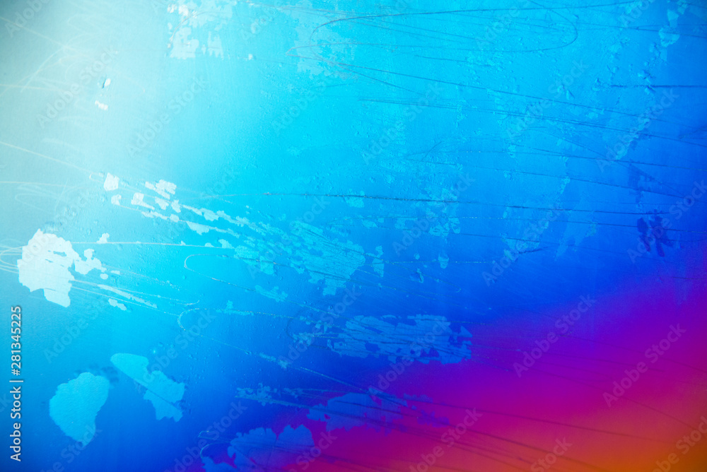 Abstract bright blue, crimson, orange background on metal with scratches and miscellaneous islands. Transfusion of colors due to sputtering of the coating by the magnetron method. Selective focus. Abstract bright blue, crimson, orange background on metal with scratches and miscellaneous islands. Transfusion of colors due to sputtering of the coating by the magnetron method. Selective focus.