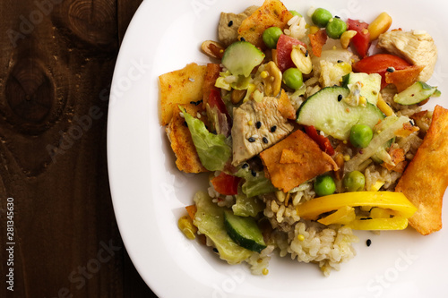 Tasty healthy dinner with chicken meat, fresh vegetables and rice on table, close up