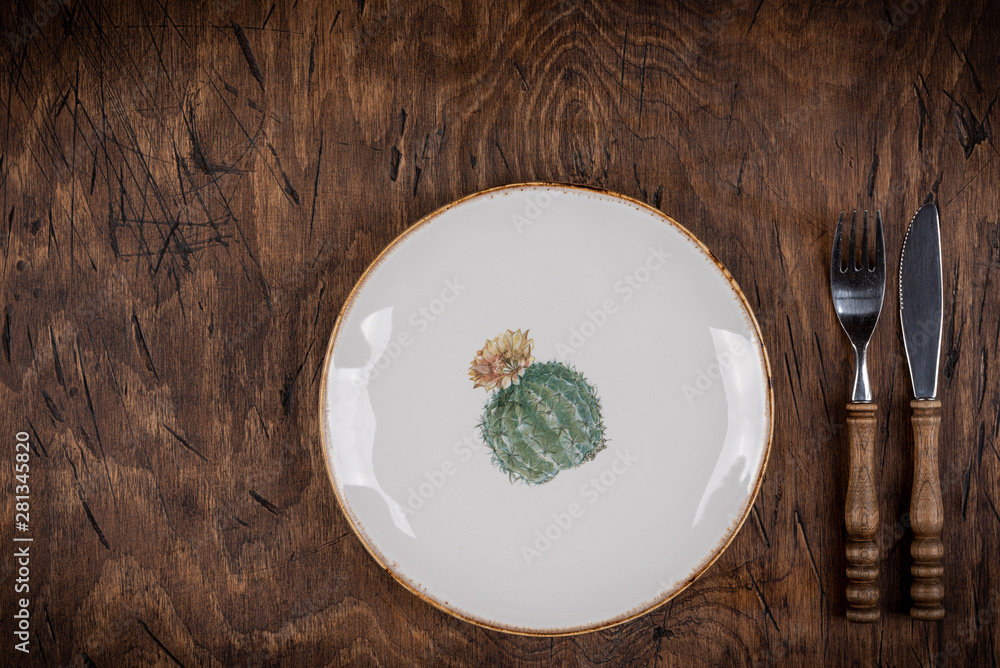 Empty plate with fork and knife on colored wooden background, top view, copy space, mock-up