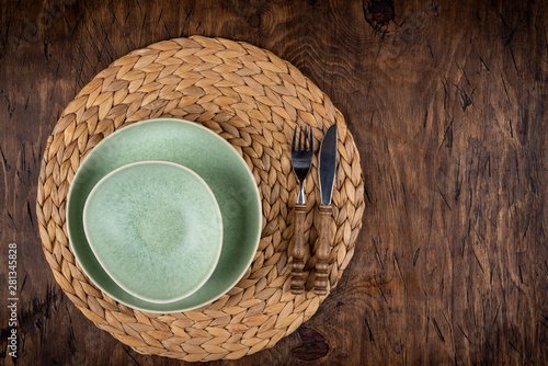 Obraz na płótnie Empty plate with fork and knife on colored wooden background, top view, copy space, mock-up w salonie