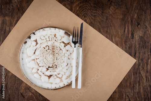 Obraz na płótnie Empty plate with fork and knife on colored wooden background, top view, copy space, mock-up w salonie