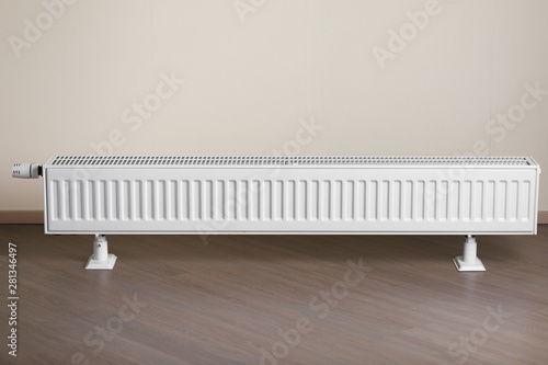 Wallpaper Mural heating radiator with thermostatic knob in the living room Torontodigital.ca