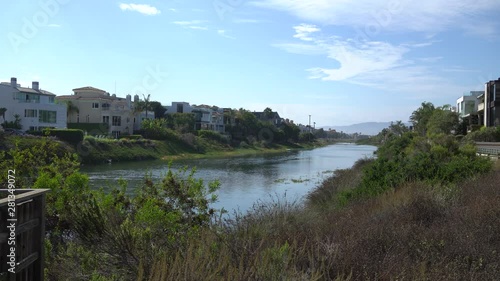 Beautiful view of Marina del Rey lagoon. Channel with ocean water. Private houses on both sides of shore. Warm Sunny Day in Los Angeles California.