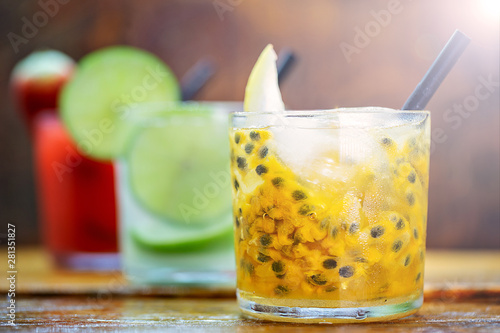 Traditional brazilian caipirinha alcoholic cocktail with sugar, mint and brown sugar. Fruit with cachaça, Brazilian tradition. photo