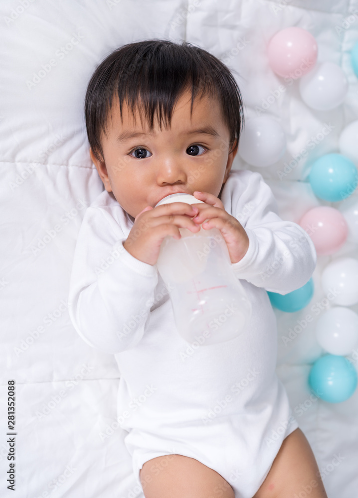 baby drink milk from a bottle on bed baby drink milk from a bottle on bed