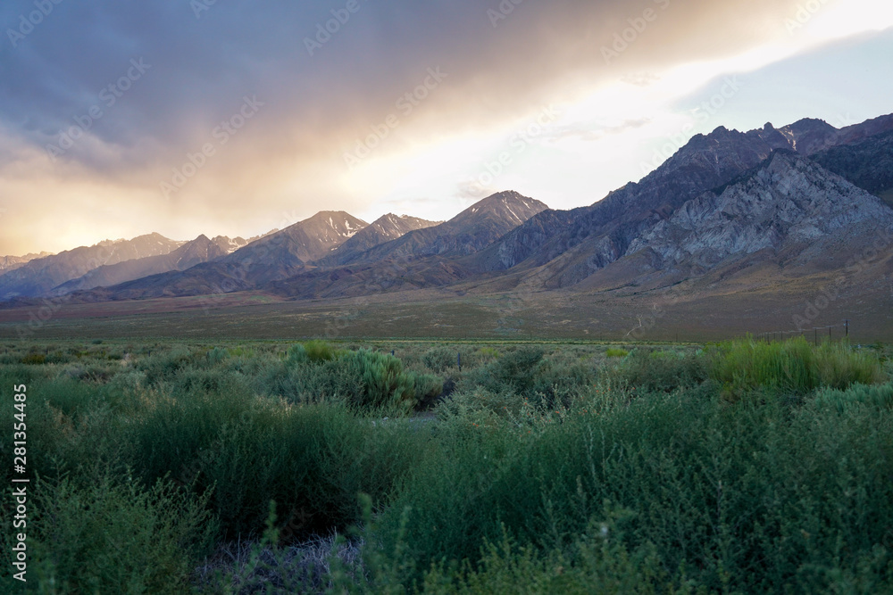 Mountain range colorful sunset with clouds before storm , Eastern Sierra Mountains, Mono County, California, USA