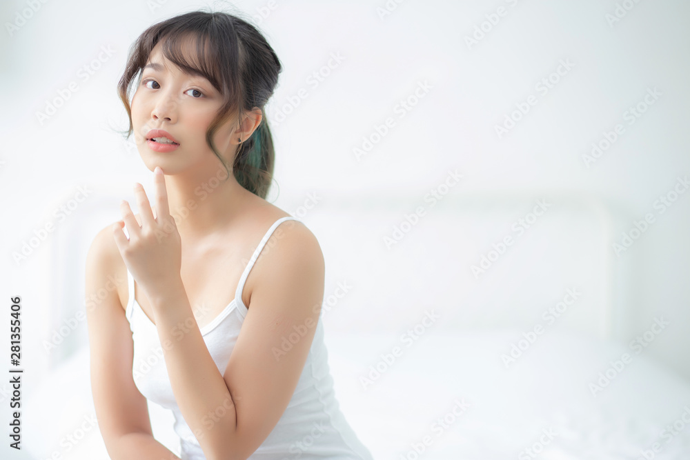 Portrait of beautiful young asian woman smile while wake up healthy and wellness with sunrise at morning in the bedroom, asia girl skin care with happy with fresh, lifestyle and relax concept. Portrait of beautiful young asian woman smile while wake up healthy and wellness with sunrise at morning in the bedroom, asia girl skin care with happy with fresh, lifestyle and relax concept.